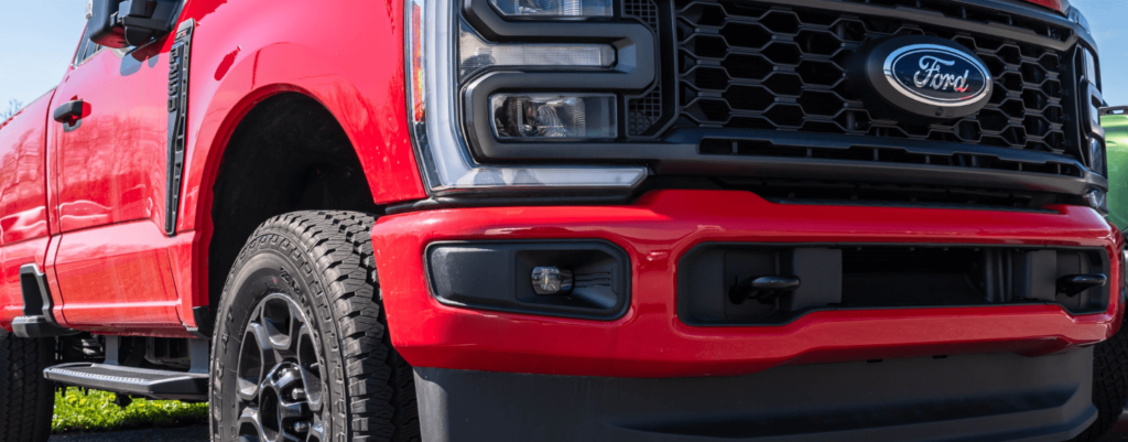 What Should I Know About Light Duty Diesel Repair for My Pickup in York, PA? :Low-angle view of a red Ford Truck, highlighting its aggressive grille, modern headlights, and sturdy tires, emphasizing its strength and durability.