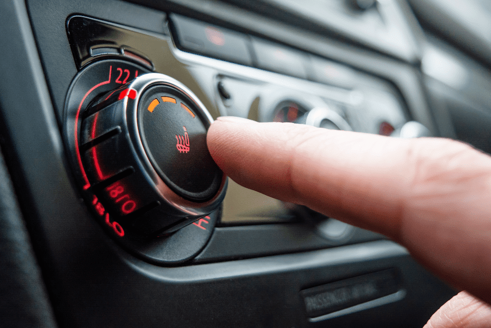 car heater repair, Auto repair in New Oxford, PA at Premier Auto Works Inc. A close-up image of a car's climate control knob being adjusted to activate the seat heater.