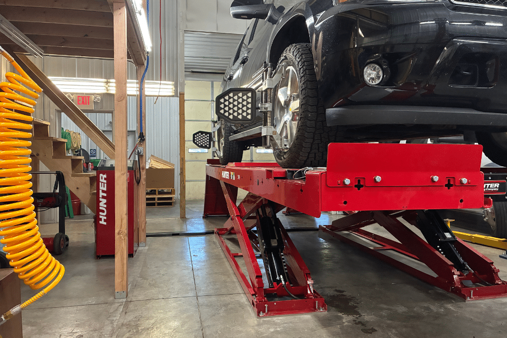 wheel alignment, Auto repair in New Oxford, PA at Premier Auto Works Inc. Image of a truck on a Hunter lift inside the shop, highlighting professional service and advanced equipment for diesel maintenance and upgrades.